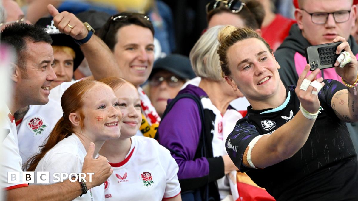 Portia Woodman Wickliffe takes a photo with a fan