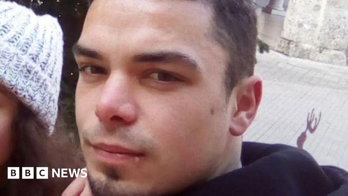 Close-up of Leonard Farruku looking at the camera. He has smartly cropped dark hair and a stubble goatee beard and has a serious expression.