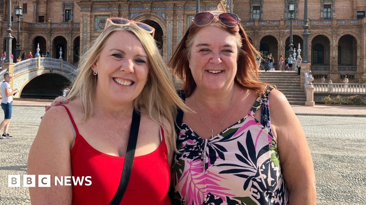 Two female Forest fans stood together smiling in Seville.