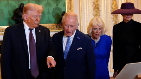 PA Media (left-right) US President Donald Trump, King Charles III, Queen Camilla and First Lady Melania Trump viewing items on display at the Royal Collection exhibition
