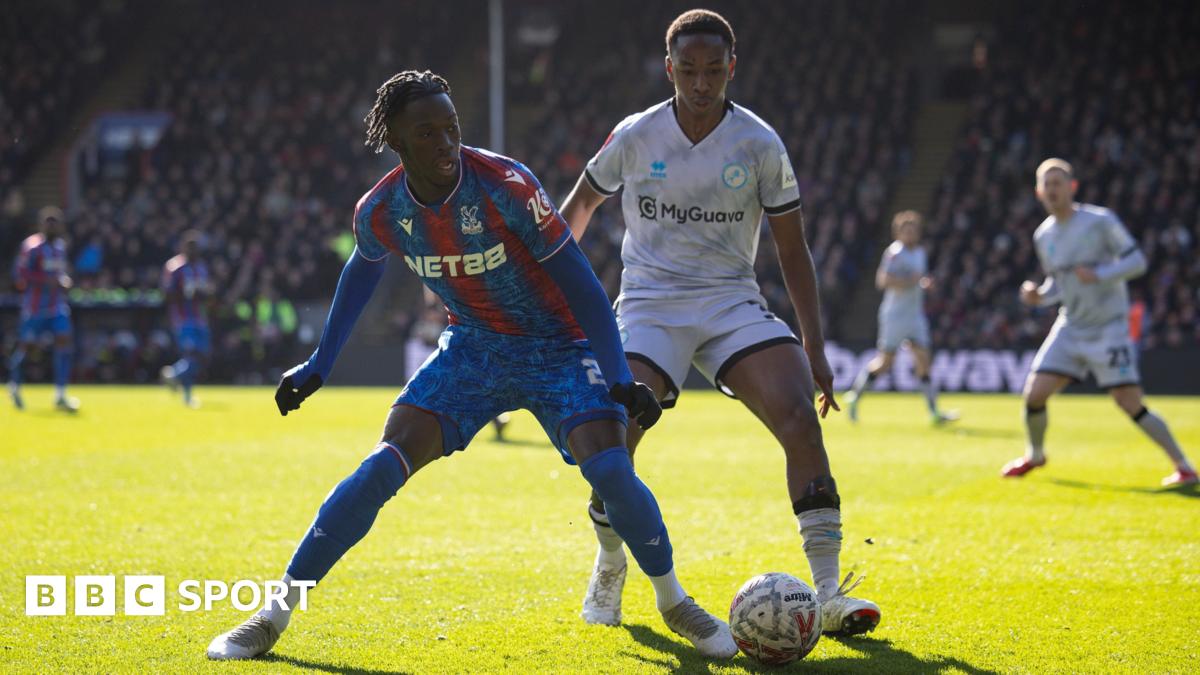 Romain Esse of Crystal Palace shields the ball under pressure from Millwall's Raees Bangura-Williams in the sunshine at Selhurst Park