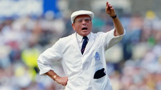 Dickie Bird in a white cap and coat