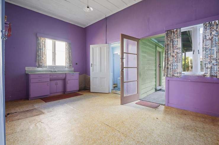 The two-bedroom green villa on Church Street, in Auckland's Onehunga, will be recognisable to Dress Smart shoppers. Photo / Supplied