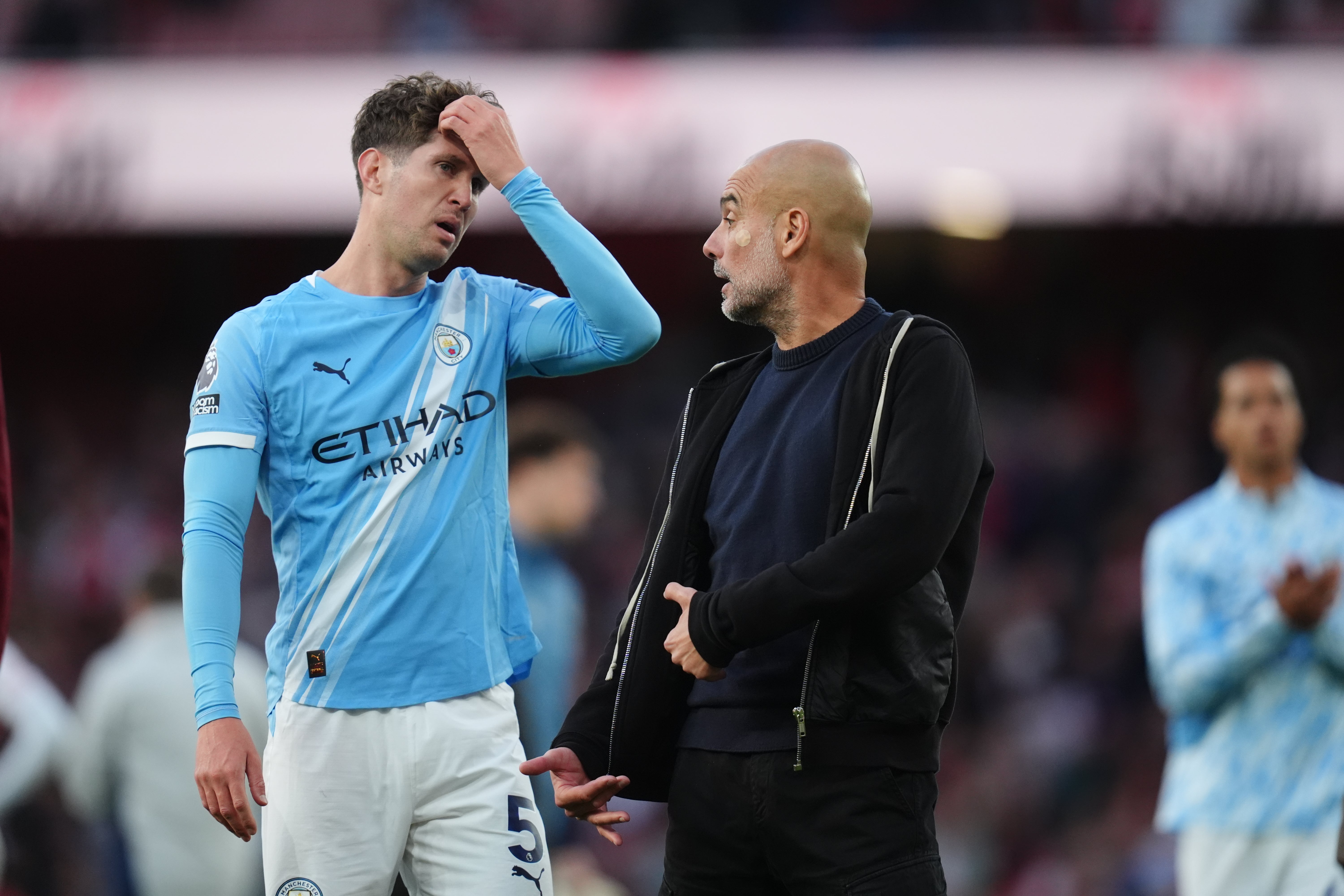 Pep Guardiola in discussion with John Stones at full-time (John Walton/PA)