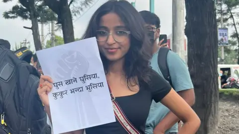 Tanuja Pandey Tanuja Pandey holding a paper showing an anti-corruption slogan during the Gen-Z protests in Nepal 