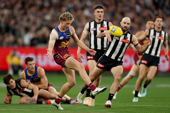 Jaspa Fletcher of the Lions kicks the ball.