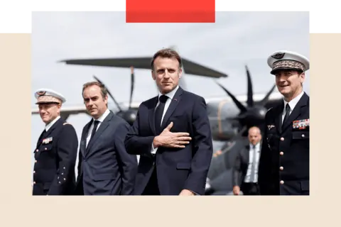 BENOIT TESSIER/POOL/AFP via Getty Images Emmanuel Macron (C) next to Sebastien Lecornu 