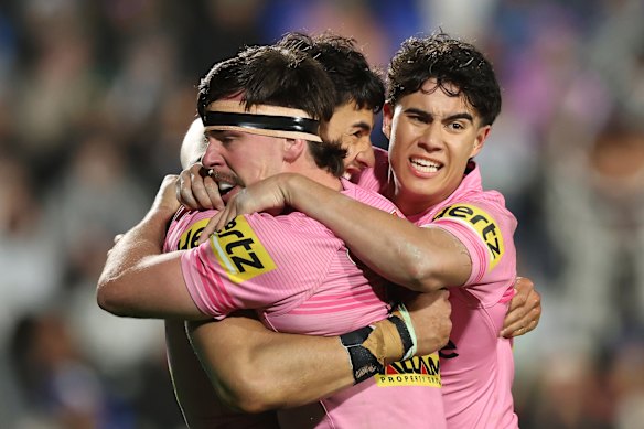 Casey McLean and Panthers teammates celebrate his try in the second half.