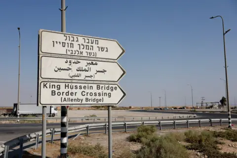 Reuters Road signs point to the currently closed Allenby Bridge Crossing between West Bank and Jordan, in the Israeli-occupied West Bank. 
