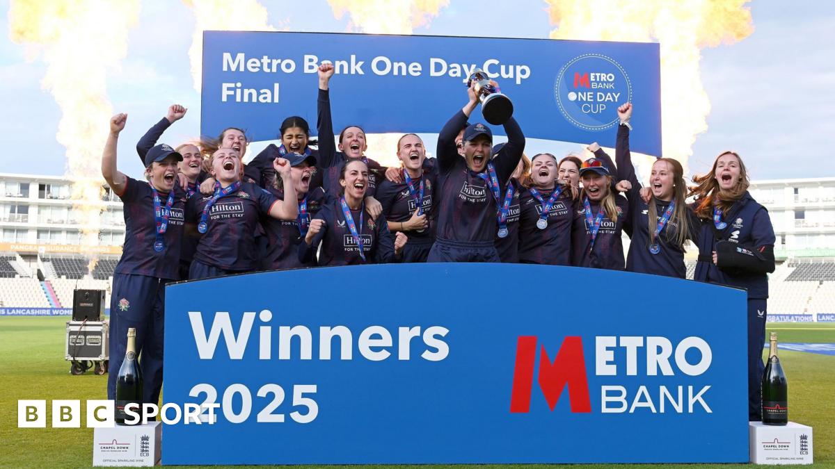 Lancashire captain Ellie Threlkeld lifts the One-Day Cup trophy along with her team-mates on the podium