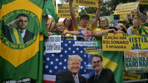 Getty Images Supporters of Brazil's former president Jair Bolsonaro, hold allusive signs a demonstration during Independence Day, in Sao Paulo, Brazil on September 7, 2025.