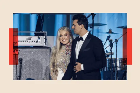 Samuel Corum/Getty Images Charlie Kirk and and his wife Erika Lane Frantzve  on stage 
