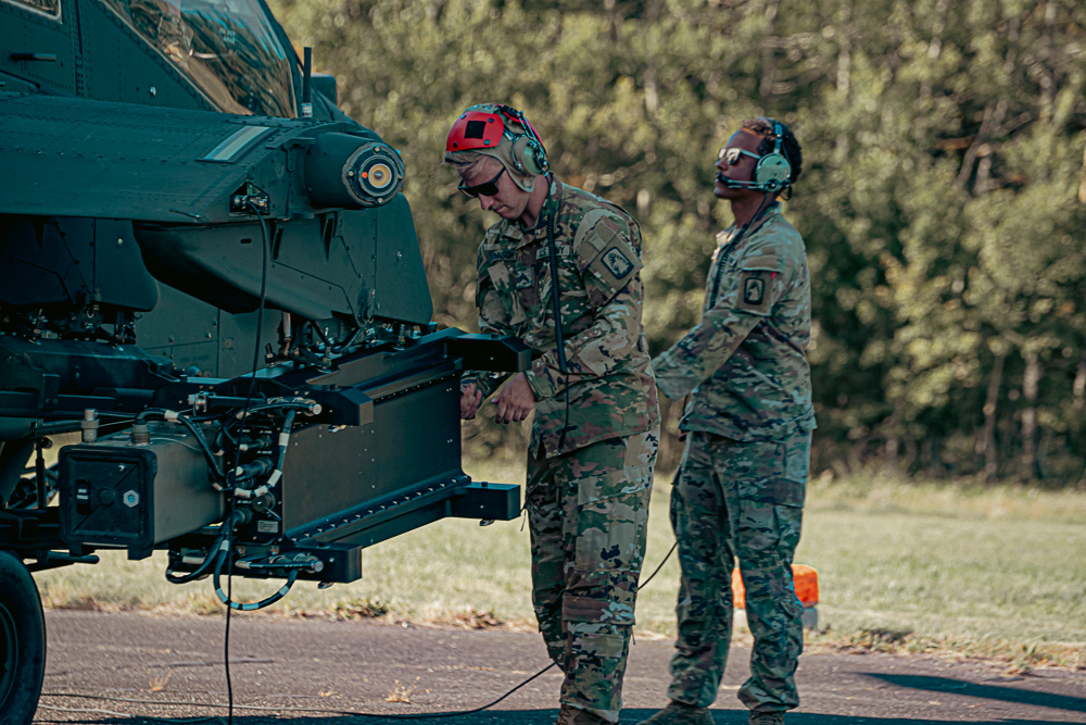 U.S. Army Sgt. Andrew Johnson, AH-64 Armament, Electrical, and Avionics System Repairer, and U.S. Army Spc. Rashuan Skoda, an AH-64 Attack Helicopter Repairer with the 1st Attack Battalion, 3rd Aviation Regiment, conduct pre-flight checks on an AH-64E Apache helicopter. The 12th Combat Aviation Brigade conducted a historic live-fire of the SPIKE Non-Line of Sight missile system from an AH-64E v6 Apache Guardian helicopter on Aug. 27 in Ustka, Poland. This landmark event marked the first employment of the missile in the European theater, significantly increasing the U.S. Army’s lethality and combat capability.