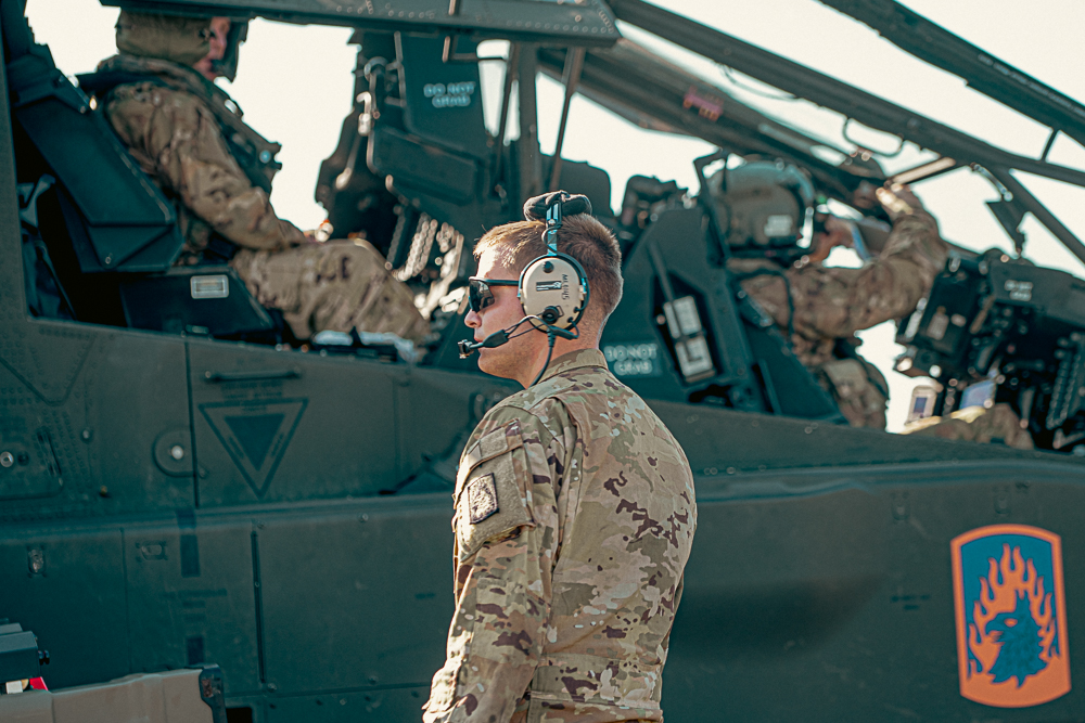 U.S. Army Spc. Levi Miller, an AH-64 Attack Helicopter Repairer with the 1st Attack Battalion, 3rd Aviation Regiment, conducts pre-flight checks on an AH-64E Apache helicopter. The 12th Combat Aviation Brigade conducted a historic live-fire of the SPIKE Non-Line of Sight missile system from an AH-64E v6 Apache Guardian helicopter on Aug. 27 in Ustka, Poland. This landmark event marked the first employment of the missile in the European theater, significantly increasing the U.S. Army’s lethality and combat capability.