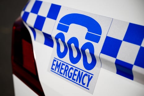 A police car with a triple-zero sign