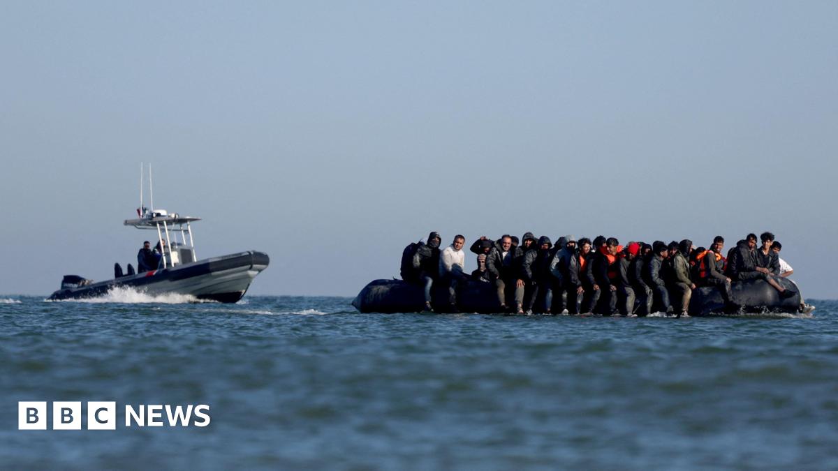 French gendarmes approach a boat of a group of people attempting to cross teh Channel to reach Britain in August.