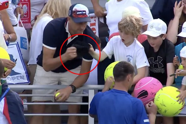 A man is caught on video snatching a match-worn cap from a young fan at the US Open.