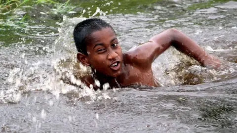 Vivek R Nair A boy swimming in a pond in Kerala 