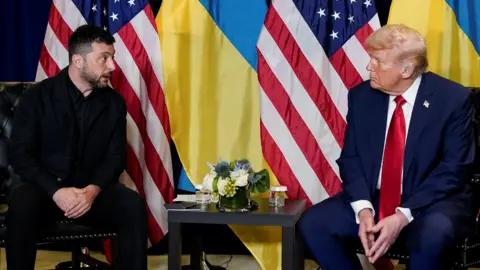 Reuters President Donald Trump meets with Ukrainian President Volodymyr Zelenskiy during the 80th United Nations General Assembly, in New York City. Zelensky wears a dark jackets and shirt, and Trump a navy suit white shirt and red tie. 