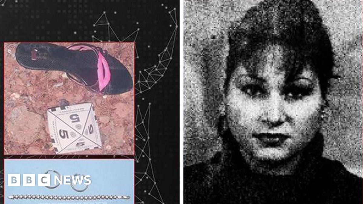 A resident walks with a shovel along a mud-covered road in Hualien on September 24, 2025, following the bursting of a barrier lake during the passing of Super Typhoon Ragasa.