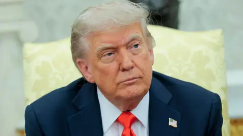 Getty Images Trump sits in the Oval Office