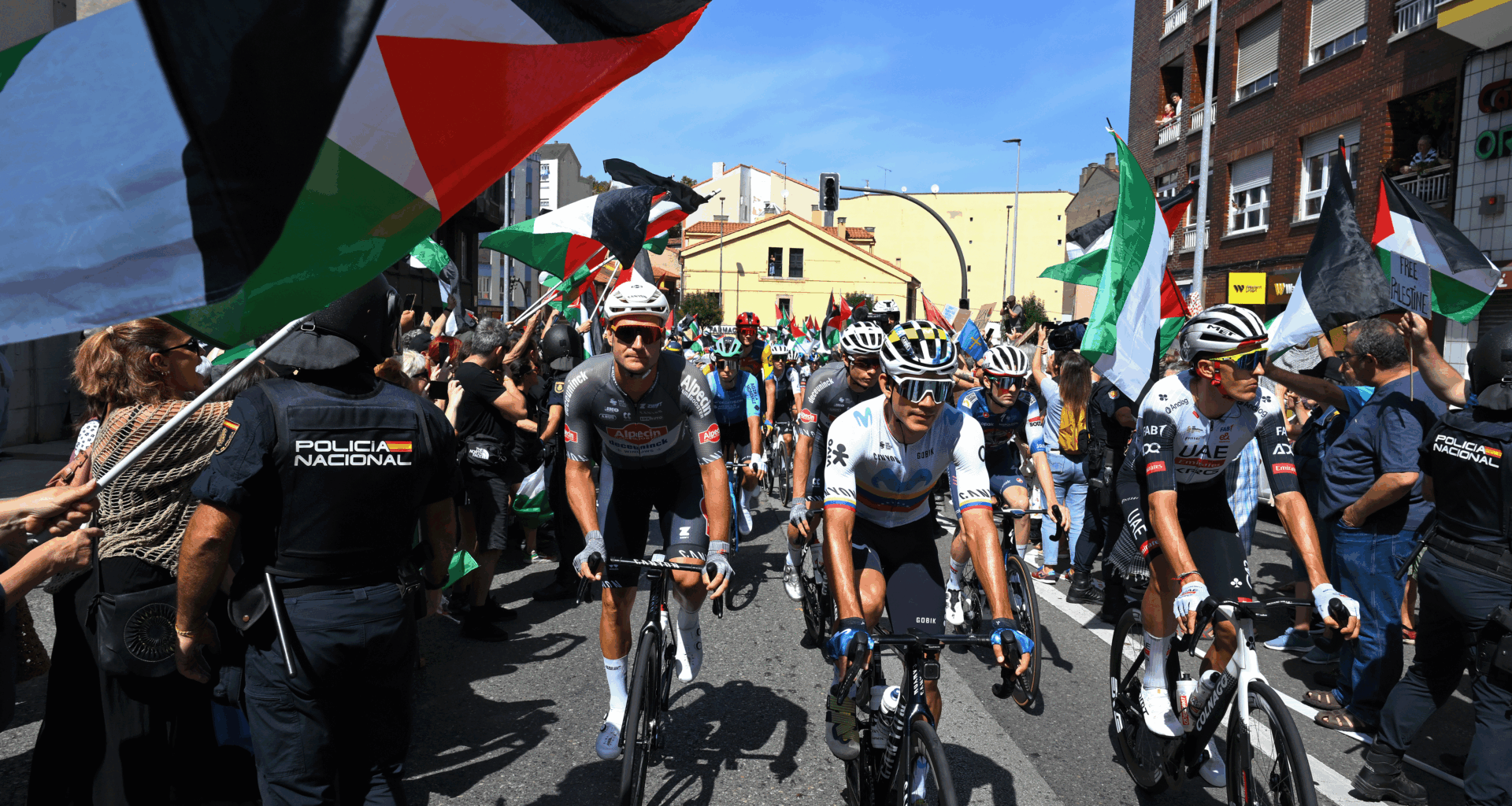 AVILES, SPAIN - SEPTEMBER 06: Pro-Palestinian protesters and the peloton prior prior to the La Vuelta - 80th Tour of Spain 2025, Stage 14 a 135.9km stage from Aviles to La Farrapona. Lagos de Somiedo 1711m / #UCIWT / on September 06, 2025 in Aviles, Spain. (Photo by Tim de Waele/Getty Images)