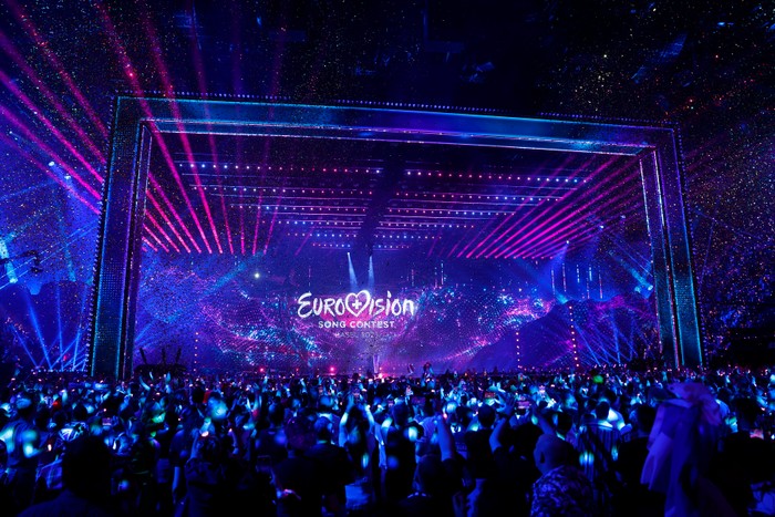 The Eurovision Song Contest 2025 Grand Final stage, with fans cheering in the arena.
