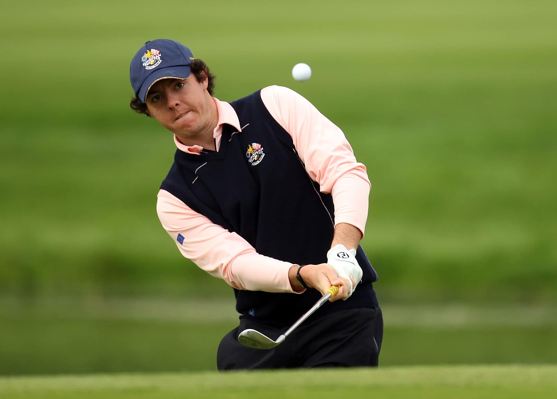 NEWPORT, WALES - SEPTEMBER 30:  Rory McIlroy of Europe chips during a practice round prior to the 2010 Ryder Cup at the Celtic Manor Resort on September 30, 2010 in Newport, Wales.  (Photo by Ross Kinnaird/Getty Images)