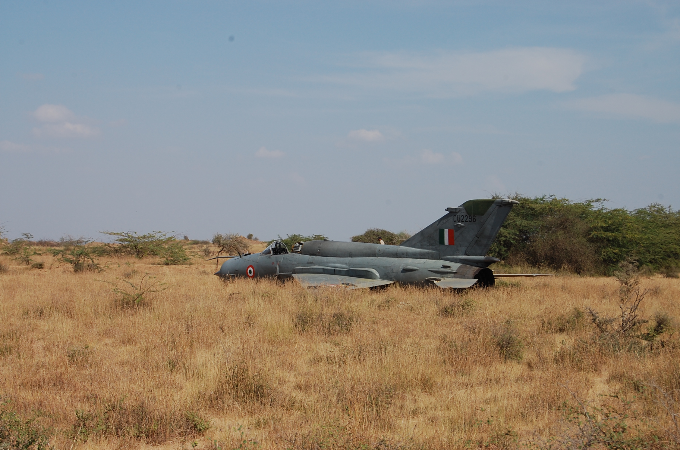 PICKED UP PICTURE - TO PAY IF USED. An Indian Air Force (IAF) personnel is seen behind an upgraded MiG-21'Bison' aircraft of the Indian Air Force which crashed after taking off from Naliya Airbase in Gujarat on November 24, 2012. The pilot of the aircraft ejected safely, sources said, adding that it was on a routine training sortie. AFP PHOTO / STR (Photo credit should read STR/AFP via Getty Images)
