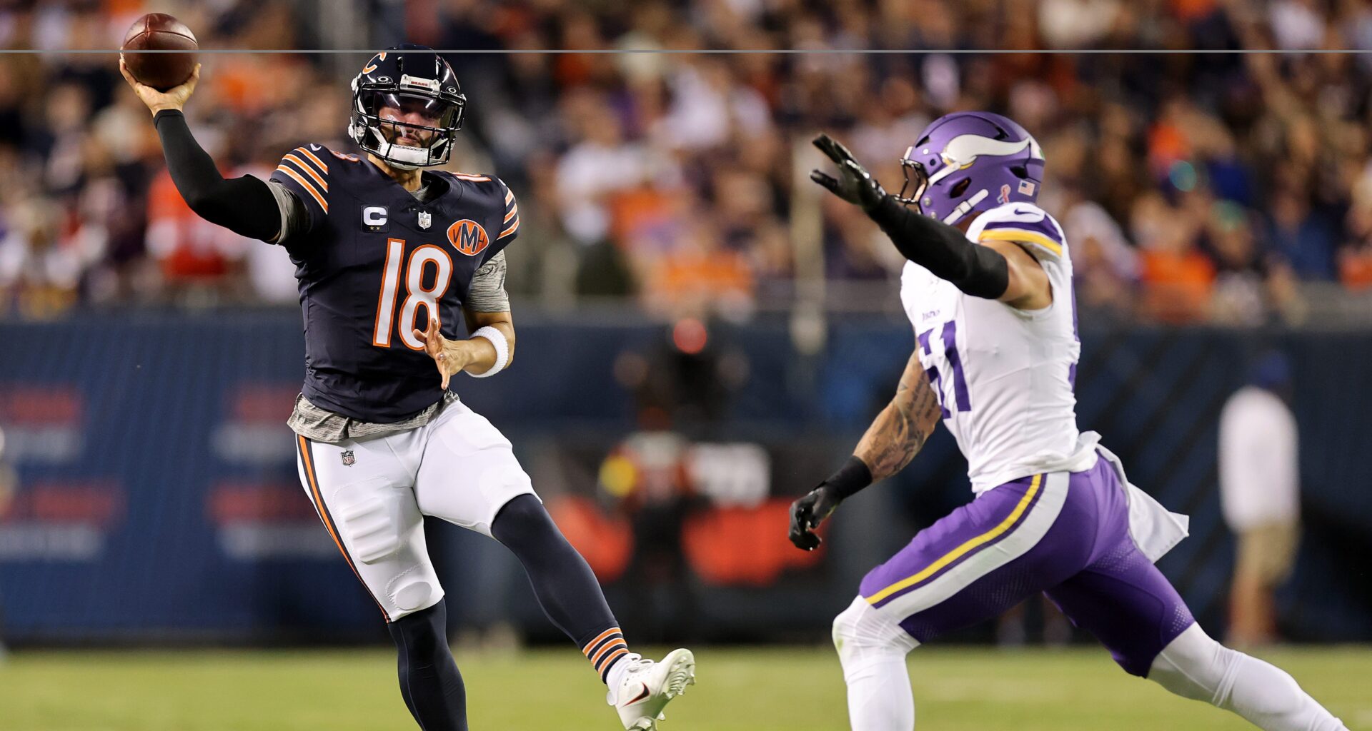 Caleb Williams throws the ball while under pressure