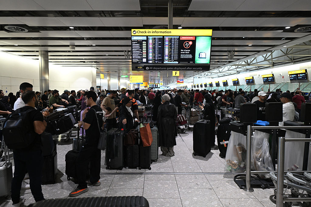 Travellers wait in terminal 4 at Heathrow Airport, west of London on September 20, 2025. Major European airports including Brussels, Berlin and London's Heathrow were Saturday hit by "cyber-related disruption" affecting check-in and baggage drop systems and causing delays, airport service provider Collins Aerospace told AFP.