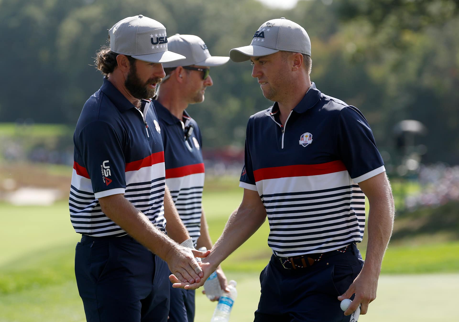 FARMINGDALE, NEW YORK - SEPTEMBER 26: Justin Thomas of Team United States high-fives teammate Cameron Young after winning the fifth hole during the Friday afternoon four-ball matches of the 2025 Ryder Cup at Black Course at Bethpage State Park Golf Course on September 26, 2025 in Farmingdale, New York. (Photo by Harry How/Getty Images)