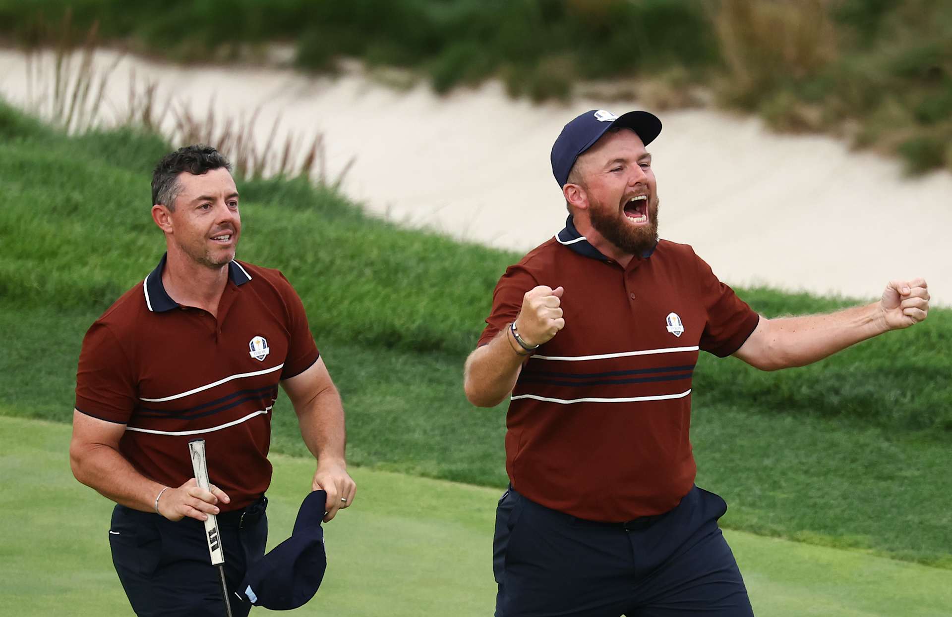 FARMINGDALE, NEW YORK - SEPTEMBER 27: Rory McIlroy and Shane Lowry of Team Europe celebrate defeating Justin Thomas and Cameron Young of Team United States 2 Up on the 18th green during the Saturday afternoon four-balls matches of the 2025 Ryder Cup at Black Course at Bethpage State Park Golf Course on September 27, 2025 in Farmingdale, New York. (Photo by Jared C. Tilton/Getty Images)