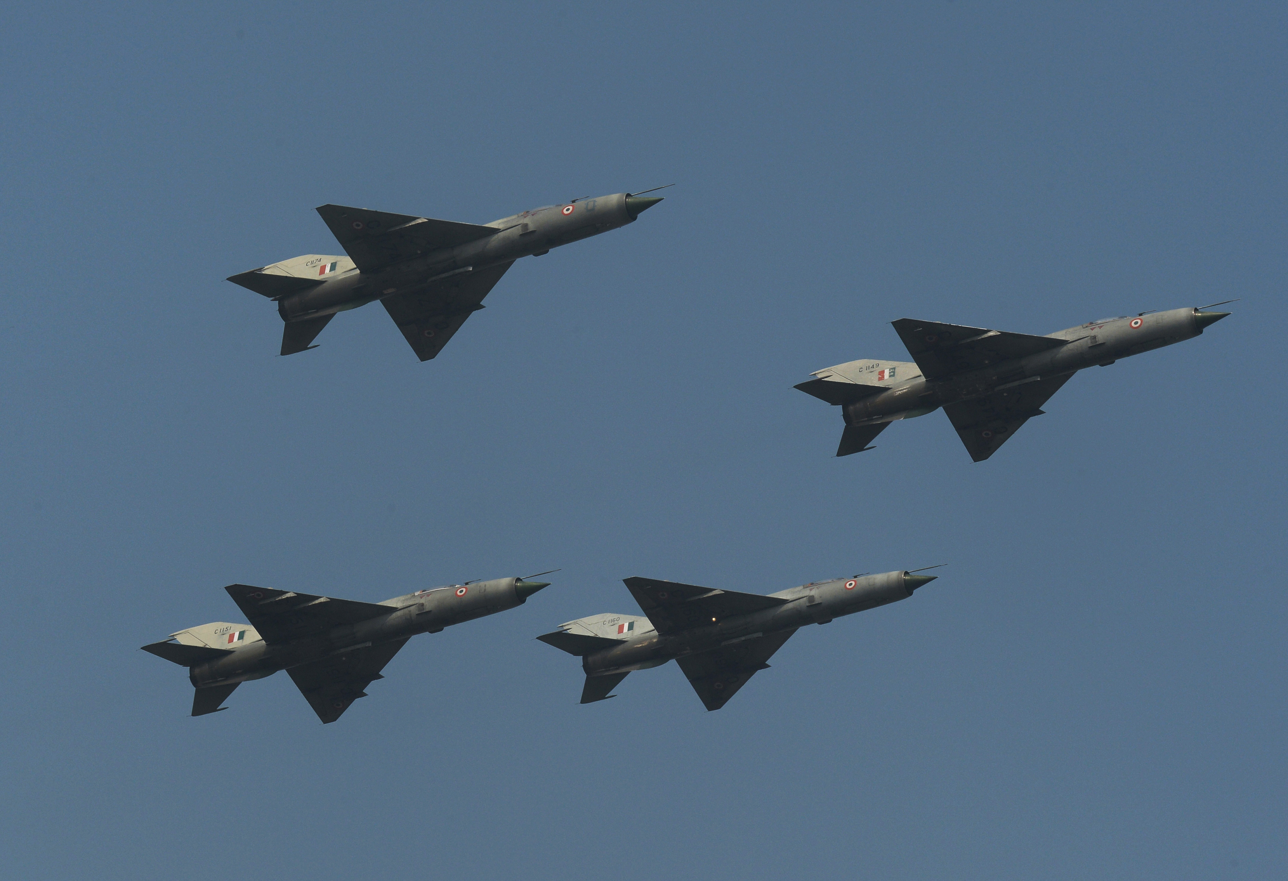 Indian Air Force of MIG 21FL fighter aircraft are seen in a 'Box' formation for the final time during a fly-past at the last ceremonial flight of the MIG 21 at a phasing out ceremony at Air Force Station Kalikunda (WB) near Kharagpur, some 110kms west of Kolkata on December 11, 2013. Three MiG-27 aircraft performed the Trishul Break Manoeuvre as a salute to the MiG-21 type 77 aircraft, which were first inducted in March-April 1963 and heralded the arrival of the Indian Air Force in the Supersonic era. AFP PHOTO/Dibyangshu SARKAR (Photo credit should read DIBYANGSHU SARKAR/AFP via Getty Images)