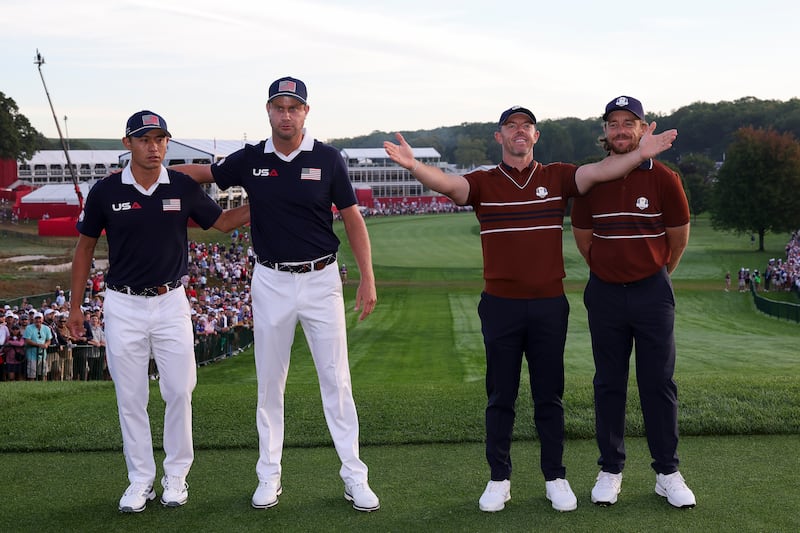 Rory McIlroy of Team Europe acknowledges the crowd alongside teammate Tommy Fleetwood as Collin Morikawa and Harris English. Photograph: Andrew Redington/Getty