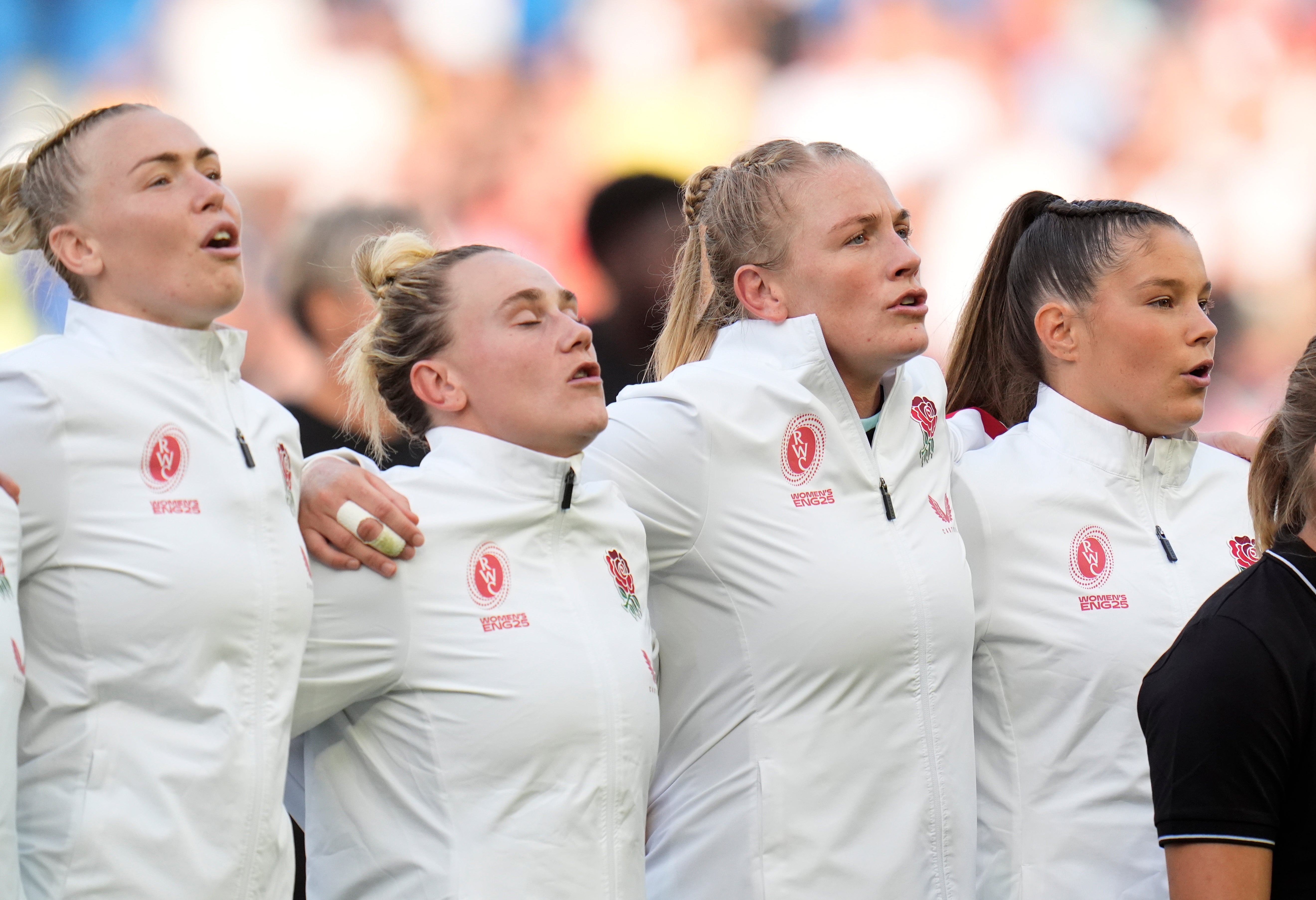 Meg Jones (second from right) sings the England national anthem