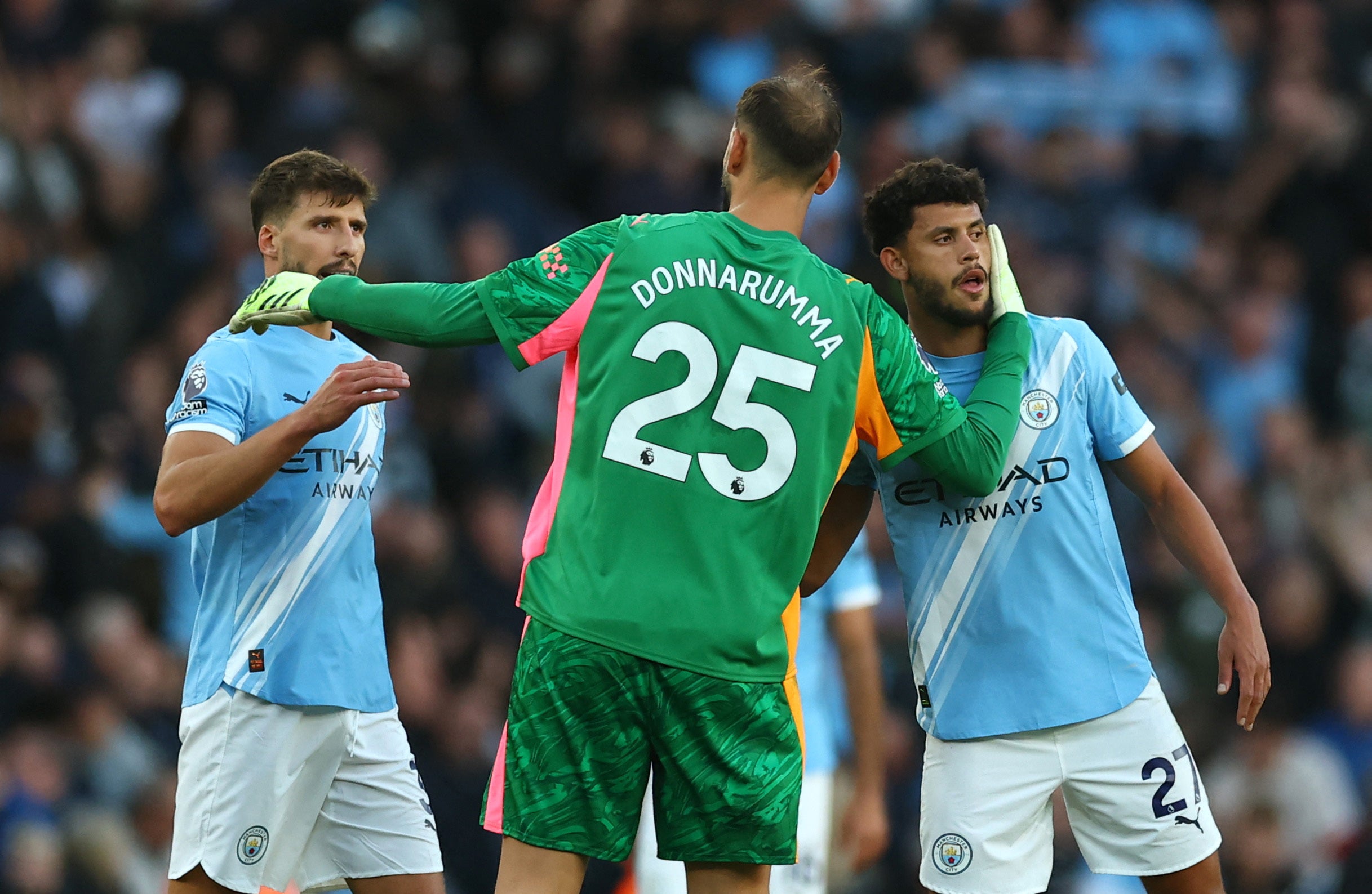 Gianluigi Donnarumma embraces his defenders after the game