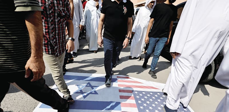 Demonstrators in Bahrain trample Israeli and US flags, October 2023  credit: Reuters/Hamad I Mohammed