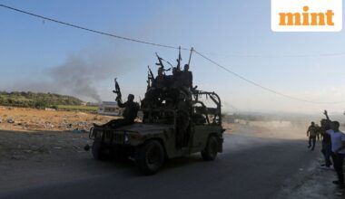 Palestinian militants ride an Israeli military vehicle that was seized by gunmen who infiltrated areas of southern Israel, in the northern Gaza Strip October 7, 2023.