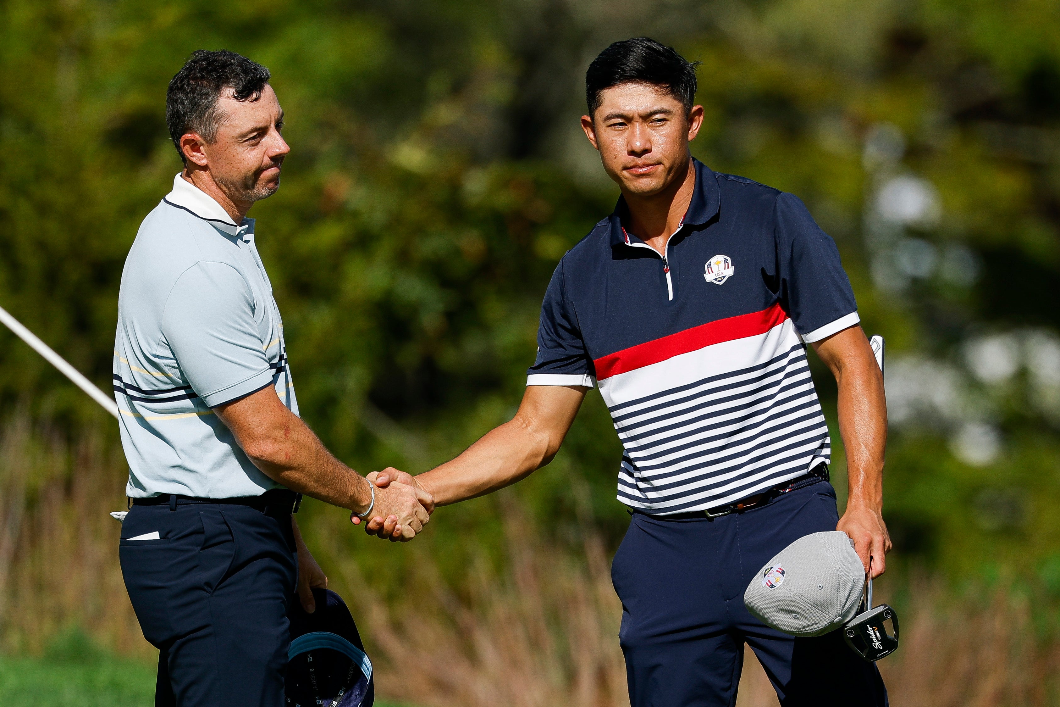 Rory McIlroy of Team Europe shakes hands with Collin Morikawa of Team United States