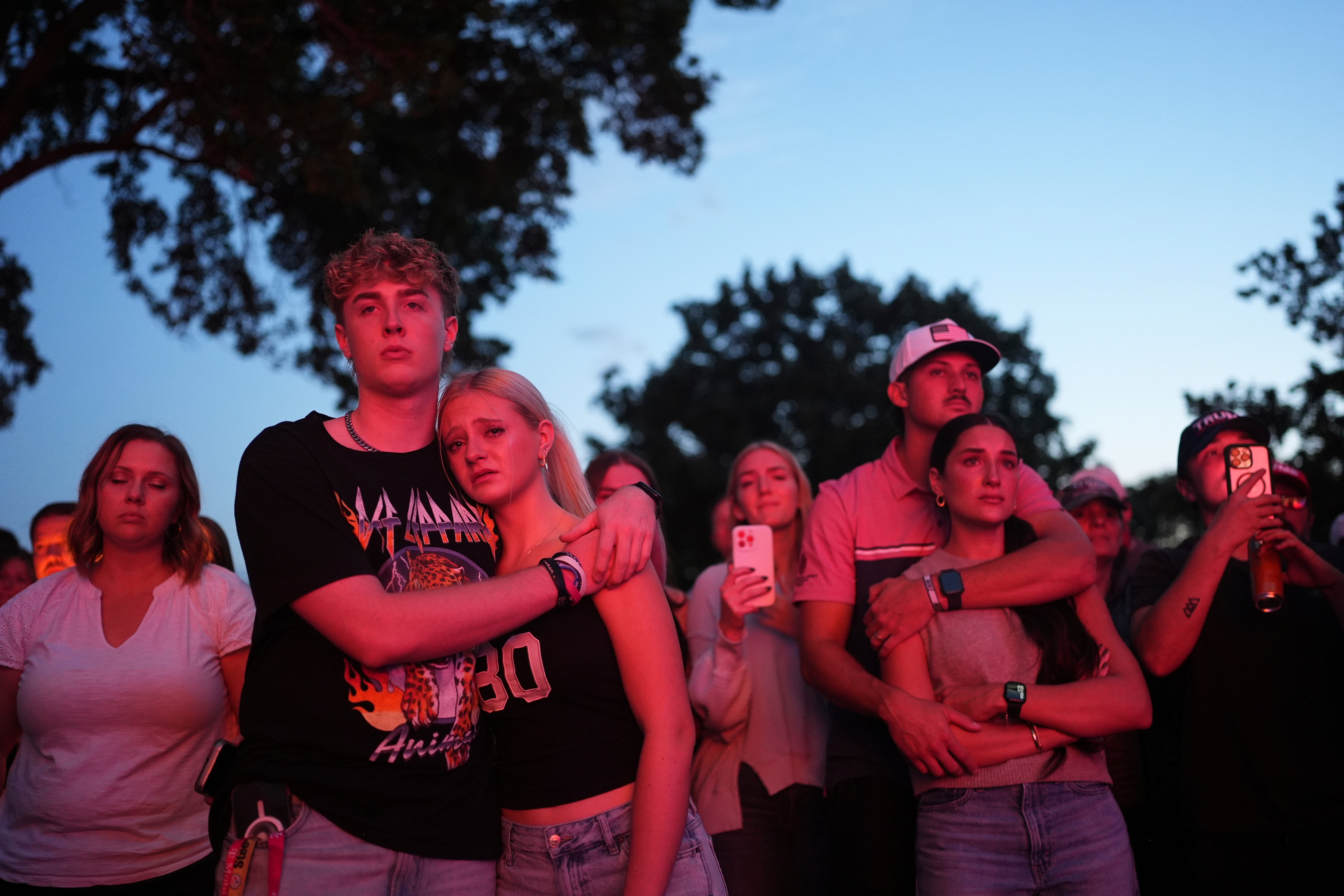 Utah Valley University students Zach Zimmerman, second from left, and Lauren Simons embrace during a vigil for Charlie Kirk, the CEO and co-founder of Turning Point USA who was shot and killed