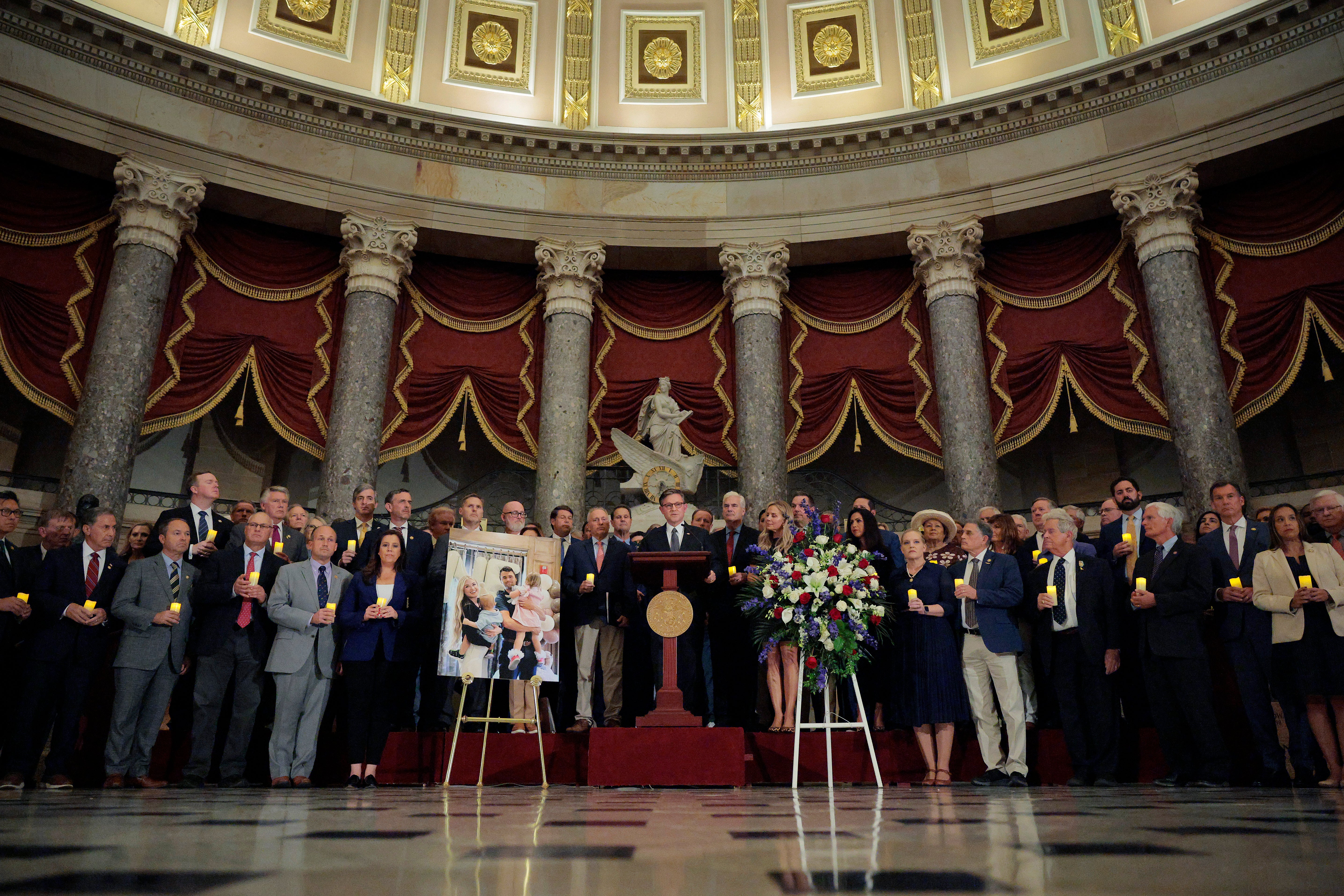 Speaker of the House Mike Johnson is surrounded by House colleagues as he speaks during a memorial vigil for Charlie Kirk in Statuary Hall on Monday