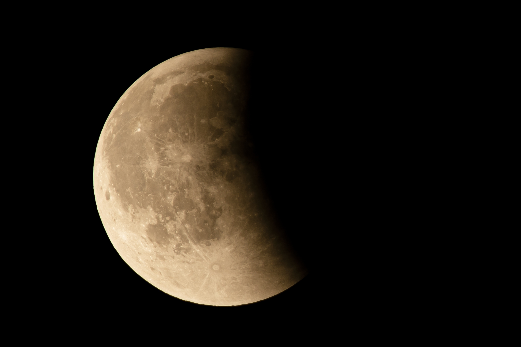 A picture of the moon with its right half bathed in shadow against a black sky.