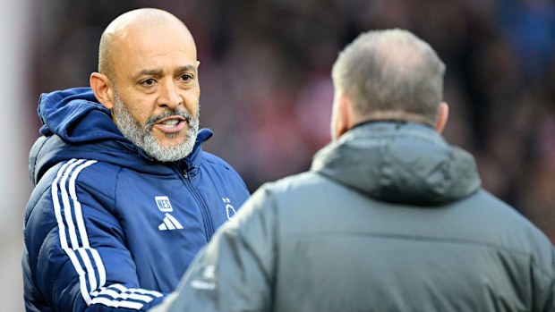 Nuno Espirito Santo interacts with Ange Postecoglou.