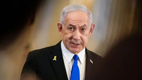 Getty Images Benjamin Netanyahu in a black suit and blue tie