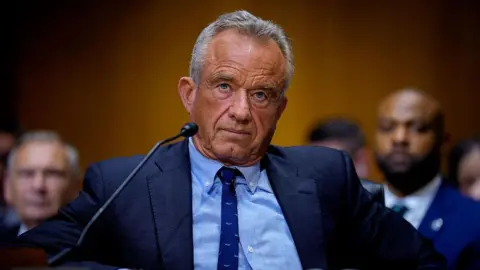 Getty Images Robert F Kennedy Jr during a committee hearing. He is wearing a dark suit and tie with a blue shirt. 