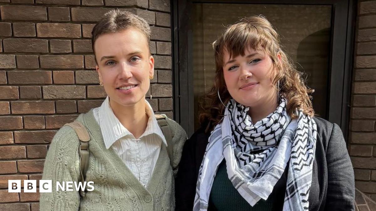 Jennifer Kowalski, 29, (left) looking directly at the camera and smiling. Next to her is Cole MacDonald, 23, who is also looking directly at the camera and smiling. The pair are both standing outside in front of a brick wall.