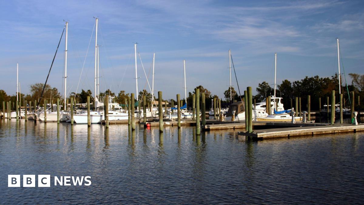 Shane Tamura in a green football jersey standing on a field