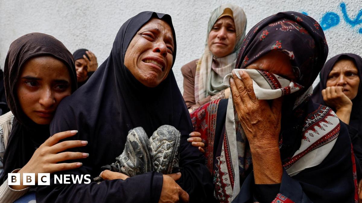 File photo showing the mother of Palestinian teenager Khaled al-Shinbari holds his shoes during his funeral at al-Shifa hospital, in Gaza City, northern Gaza (28 August 2025)