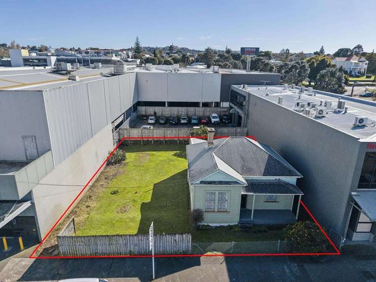 The two-bedroom green villa on Church Street, in Auckland's Onehunga, will be recognisable to Dress Smart shoppers. Photo / Supplied